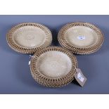 A set of eight 19th century circular salt glazed ribbon plates with basket weave moulded centres