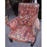 A late Victorian armchair, upholstered in a Caucasian design kelim fabric, on turned supports