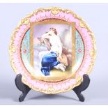 A 19th century Meissen cabinet plate with pink and gilt scroll decorated border, centre painted lady