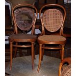 A pair of Thonet bentwood standard chairs with cane backs and seats and a small balloon back chair