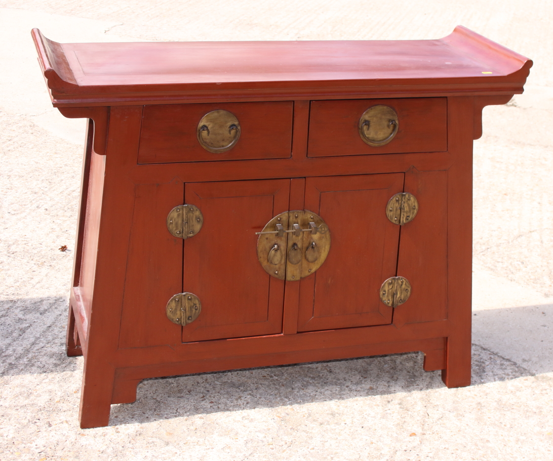 A Korean red lacquer cabinet, fitted two drawers and lower cupboard, 45" wide