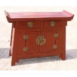 A Korean red lacquer cabinet, fitted two drawers and lower cupboard, 45" wide