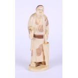 A Japanese sectional ivory okimono, man with an umbrella, 5 1/4" high (hand restored)