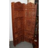 An Indian carved and pierced four-fold screen, panels 20" wide