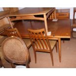 A G Plan teak dining suite comprising an extending table, four chairs and a sideboard