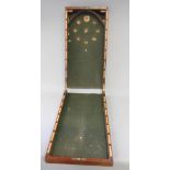 A folding mahogany bagatelle board