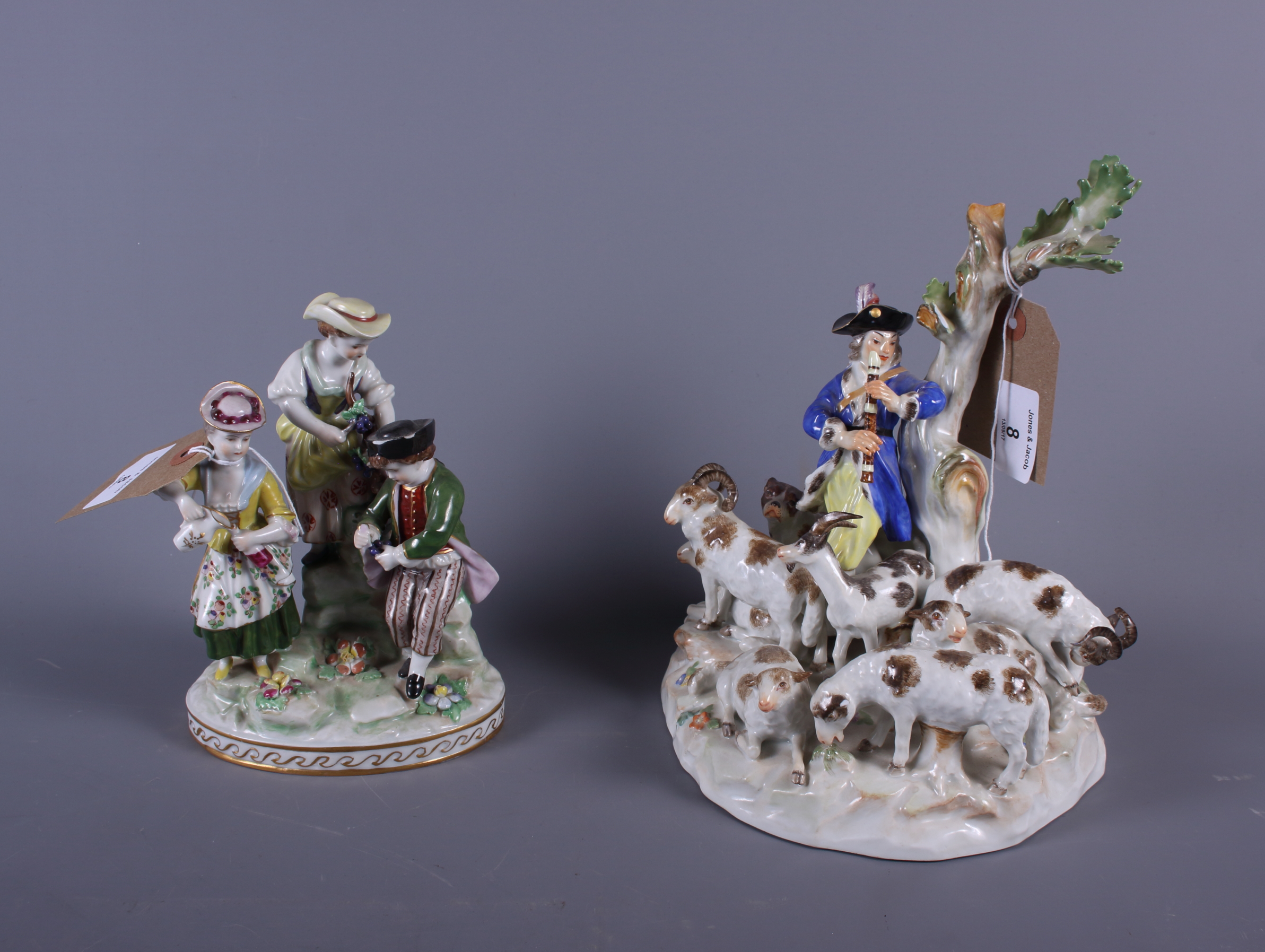 A 19th century Meissen porcelain figure group of a shepherd with dog and seven sheep and two other