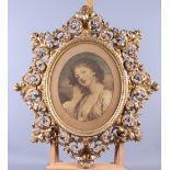 A 19th century photogravure of a girl, in Florentine carved giltwood oval scrollwork frame, aperture
