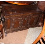 An oak and walnut coffer with two arch top panels to front and panelled lid, 41" long