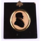 A 19th century portrait silhouette on glass, 3" x 2 3/8", in ebonised frame