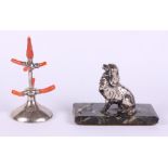 A white metal model of a King Charles spaniel, on marble base, and a silver and coral ring tree