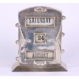 A silver perpetual desk calendar