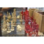 A collection of red and white carved ivory chess men, on puzzle ball bases (some damages)