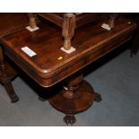 A 19th century rosewood fold-over top card table, on central baluster-shaped column and circular