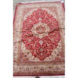 A Keshan design silky pile rug on a red ground, 75" x 55" approx