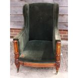 A William IV period walnut framed deep seat armchair with inverted tulip carved arms