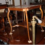 An early 20th century polished as mahogany shaped top two-tier occasional table, 26"