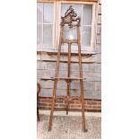 A beech framed easel with Rococo scroll pierced surmount