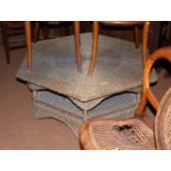 An hexagonal wicker coffee table, 36" dia, and a rectangular mahogany coffee table, on square