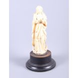 A 19th century carved ivory figure of the Madonna, on ebonised base (hands restored), 8" high