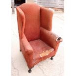 A late Georgian high wing armchair (for reupholstery)