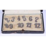 A part set of Continental silver numerical clips, numbers 2-12, in fitted box
