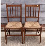 A pair of Edwardian inlaid mahogany occasional chairs with rush seats