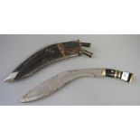 A kukri with two skinning knives, in scabbard