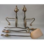 An Art Nouveau wrought iron and copper fire implement set and a pair of implement rests