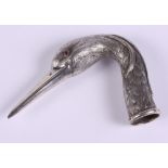 A Continental silver parasol handle, formed as a heron's head with ruby eyes