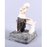 A bronze and marble statue of a naked woman seated on a bench reading, 11" high (damages)