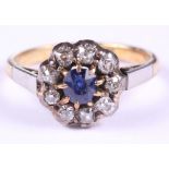 An 18ct gold and platinum, diamond and sapphire cluster ring, size P, 4.1g