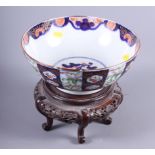 A late 19th century Chinese porcelain bowl decorated alternating blue floral and famille verte
