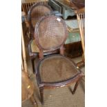 A pair of Louis XVI style standard chairs with oval caned backs