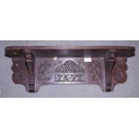 A carved oak wall shelf with carved decoration, bears date 1677, 26" wide