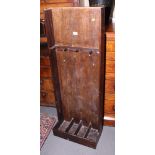 An oak gun stand for four guns, 18" wide, and a wall mounted fishing rod rack