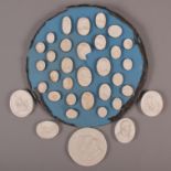 A collection of 18th century white plaster portrait medallions, some mounted on circular back board