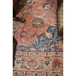 A Tabriz carpet decorated central blue floral medallion and spandrels on a red floral ground with