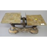 A set of Degrave & Short balance scales with brass platforms and a black cast iron set of scales