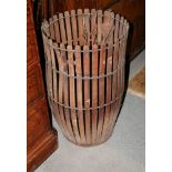 A staved wooden barrel, on four supports, and a two-handled slatted wooden bin