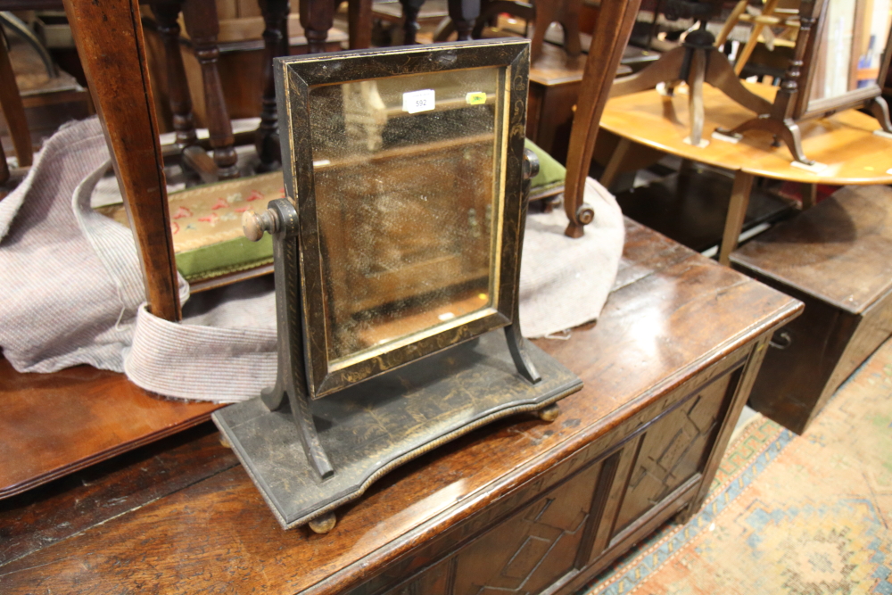 A 19th century swing frame toilet mirror with chinoiserie lacquered decoration, on plateau