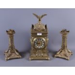 A late 19th century brass cased clock garniture with eight-day striking movement and eagle surmount,