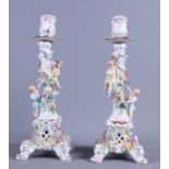 A pair of 19th century Continental porcelain floral encrusted candlesticks, 9 1/2" high