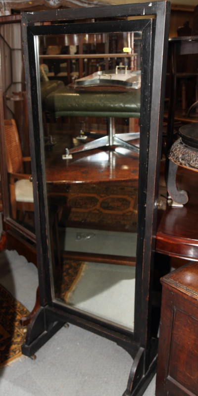 An ebonised swing frame cheval mirror, plate 17" x 47"