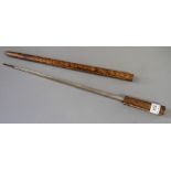 A short swordstick with square fullered blade, in a grained as walnut case, 18" long (split to