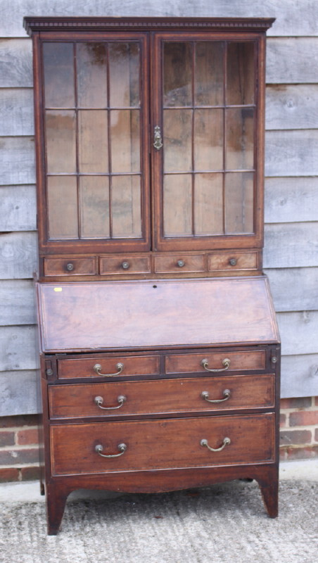 A late 19th century mahogany and banded bureau bookcase, the upper section enclosed lattice glazed