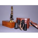 A student's brass cased microscope, in fitted case, and a pair of binoculars, in leather case