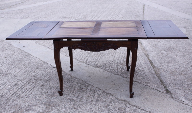 A French late 19th century fruitwood draw leaf dining table, on cabriole supports, 45" x 78" when