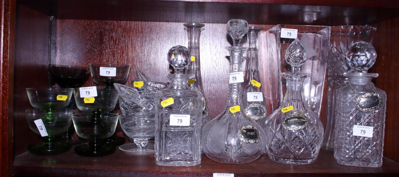 A pair of conical cut glass decanters and stoppers, two spirit decanters, two bulbous decanters
