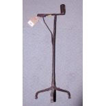 A wrought iron rush light holder/candlestick, on tripod base, 23" high